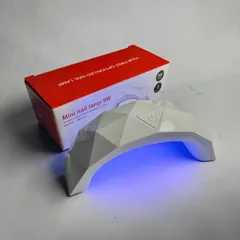 Mini LED-Lichthärtungsgerät 9 W, eingeschaltet neben der Verpackung